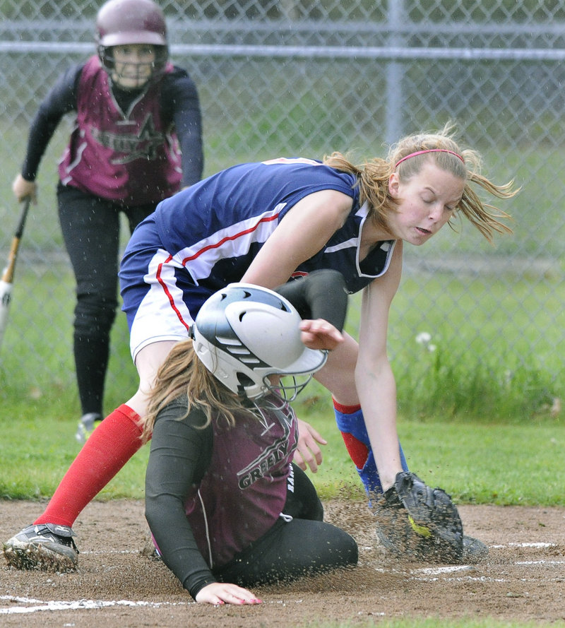 Lindsey Arsenault of Greely scores the game's first run as Gray-New Gloucester pitcher Stephanie Greaton covers the plate during Greely's 9-3 win Monday.