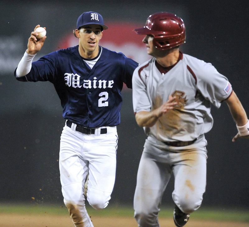 Michael Fransoso of the University of Maine has the ball right where he had it most of the night Tuesday at Hadlock Field – in his hand and ready for a putout. Fransoso, who had a hand in 11 of the 27 outs, chases down Tom Bourdon of BC, caught in a rundown.