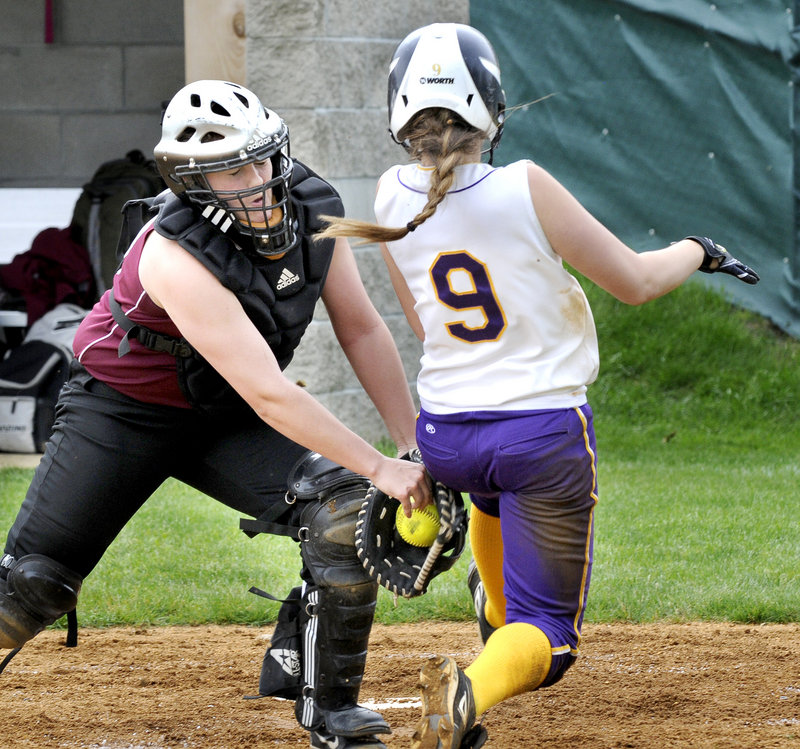 Gorham catcher Kara Stahl tags out Brittany Bell of Cheverus, who was attempting to score Wednesday during Cheverus’ 6-1 victory in an SMAA softball game at Portland.