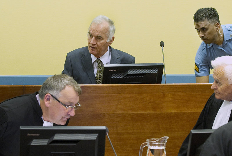 Former Bosnian Serb military commander Gen. Ratko Mladic, center, appears Wednesday at the start of his trial on charges including genocide.