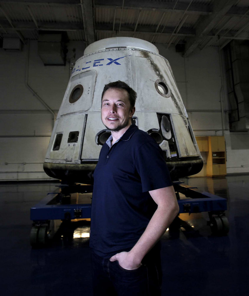 CEO Elon Musk stands with the SpaceX Dragon capsule at the company in Hawthorne, Calif. A Dragon scheduled to launch Saturday will carry cargo into orbit, and three days later dock with the International Space Station.