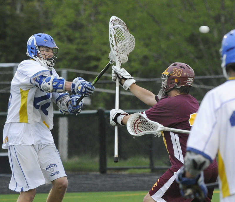 Charlie Fay of Falmouth, left, scores the fifth goal for the Yachtsmen, shooting past Will Goduti of Cape Elizabeth during the first half of the Yachtsmen’s 14-12 victory Wednesday night. Each team has one boys’ lacrosse loss this season – to the other.