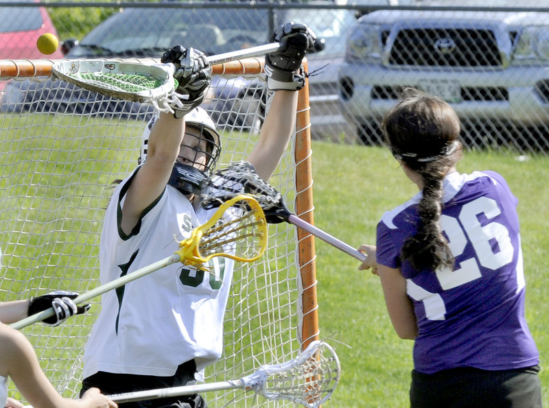 Anastasia Muca of Deering finds room to get the ball past goalie Alicia Hoyt of Bonny Eagle to score a goal Thursday during their schoolgirl lacrosse game. Hoyt made 15 saves in Bonny Eagle’s 16-7 victory.