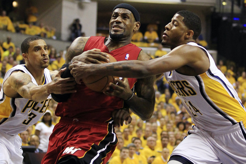 LeBron James of the Miami Heat heads to the basket Thursday night against George Hill, left, and Paul George of the Pacers. Indiana won 94-75 and has a 2-1 series lead.