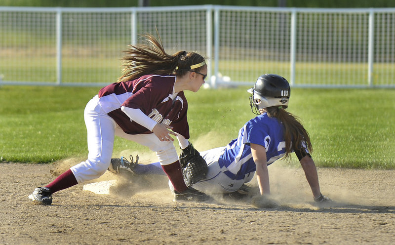 Meg Cadigan of Kennebunk slides safely into second base with a steal in the sixth inning as Thornton Academy shortstop Bailey Tremblay applies the tag.