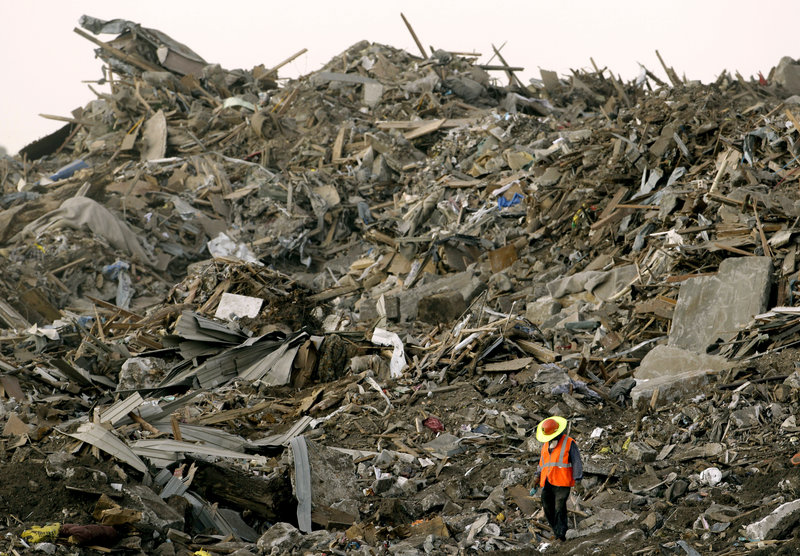 A worker walks amid a landfill in Galena, Kan., in 2011, where tornado debris had been hauled from nearby Joplin, Mo. The tornado was the costliest since 1950, at $2.8 billion.