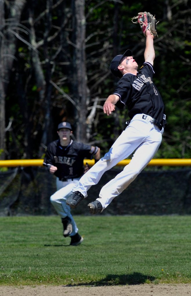Second baseman Will McAdoo of Greely leaps to snare a potential run-scoring single as center fielder Jimmy Whitaker moves in against Falmouth.