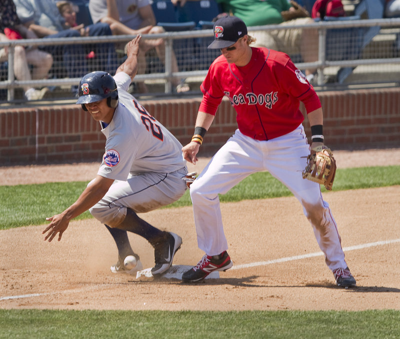 Kolbrin Vitek can’t hold on to the ball as Binghamton’s Pedro Zapata takes third base on a throwing error after stealing second. Zapata had two stolen bases and scored three runs in Binghamton’s 11-7 victory.