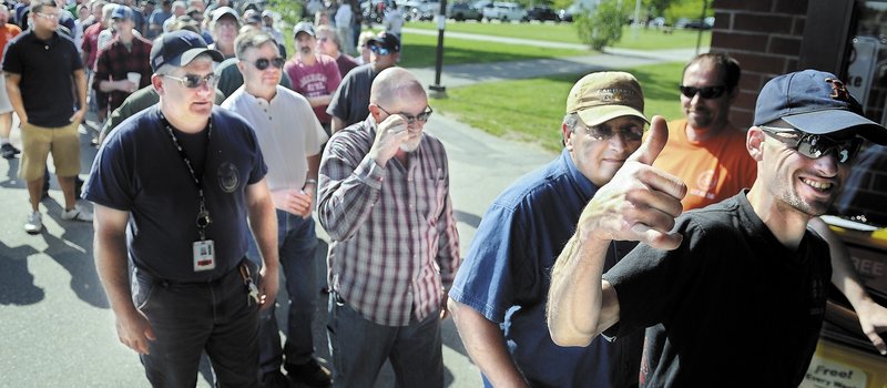 A member of Local S6 gives the thumbs-up Sunday before voting at the Augusta Civic Center on a new contract with Bath Iron Works. Members of the International Association of Machinists and Aerospace Workers voted to ratify the four-year agreement.