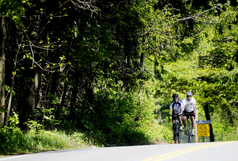 Sonja Swanberg and her husband, Bob Johnson, bike Monday along Shore Road in Cape Elizabeth. The South Portland couple said they ride or run along the road five or six times a week, and they look forward to using the new 2.2-mile path when on foot.
