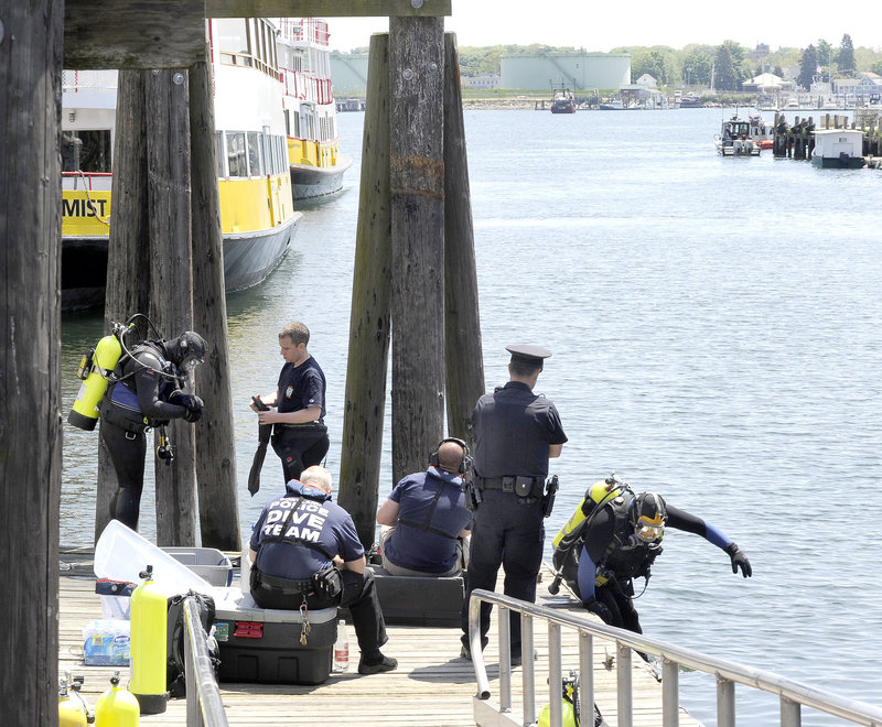 Portland police divers prepare to search the waters between the Maine State Pier and Maine Wharf for Nathan Bihlmaier, who disappeared in the Old Port early Sunday.