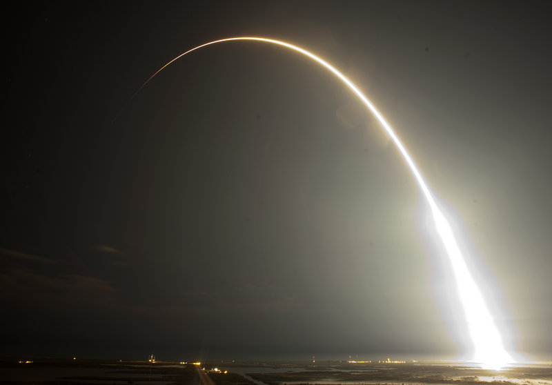 The Falcon 9 SpaceX rocket is seen during a time exposure, above, after it lifts off from the Cape Canaveral Air Force Station in Cape Canaveral, Fla., early Tuesday, below. This launch marks the first time a private company sends its own rocket to deliver supplies to the International Space Station.