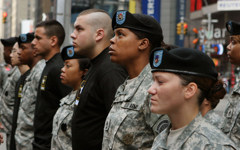 Newly enlisted Army recruits, in black shirts, join recruiting officers in a ceremony in New York in 2006.