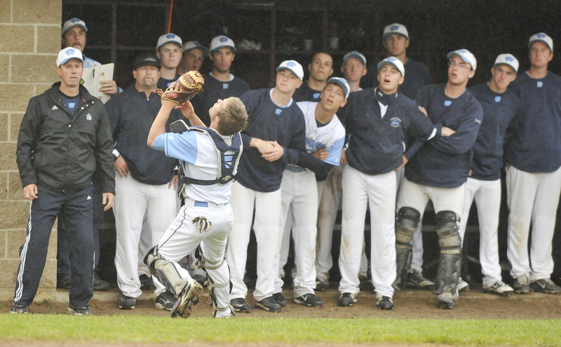 Westbrook catcher Kyle Heath gets plenty of encouragement Tuesday night while settling under a foul pop fly in front of the Blue Blazes’ bench. Heath made the catch but Westbrook lost the Telegram League game at Scarborough, 2-0.