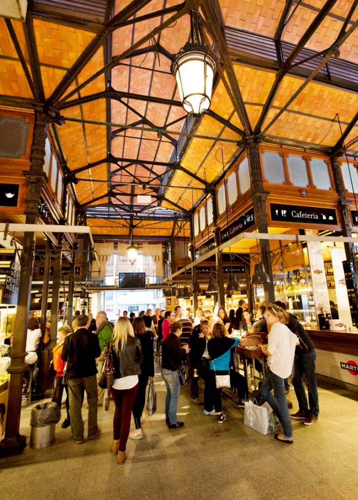 The Mercado de San Miguel in Madrid, a market where locals and tourists mingle happily.