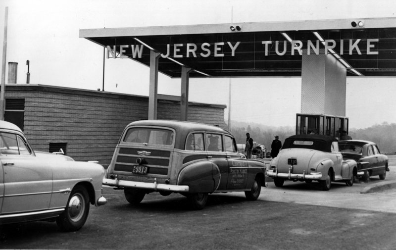 Cars pass through a toll gate of the New Jersey Turnpike as the first 53-mile section between Deepwater and Bordertown, N.J., opens on Nov. 5, 1951. Since then, tolls have been allowed on interstates in 15 states, and other states are fighting limits on tolling.