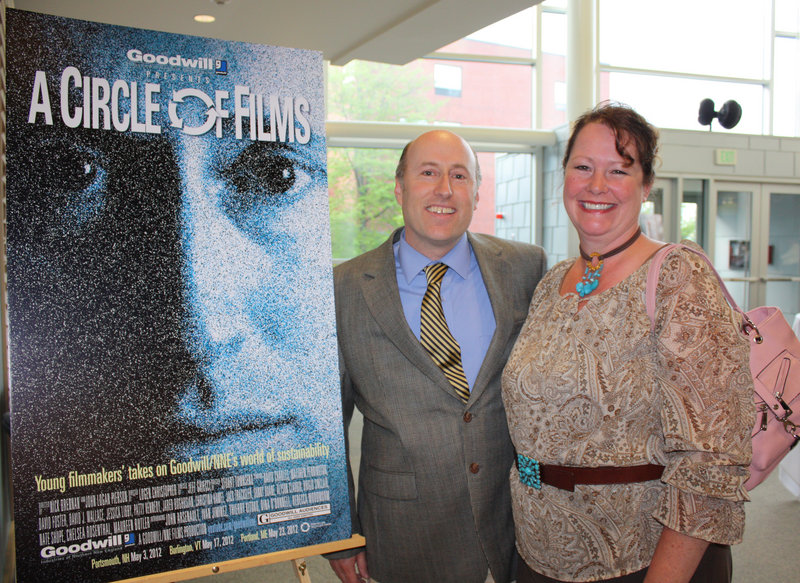 Actors David Wallace of Brunswick and Patty Kennedy of Freeport, next to the poster for the film "Circles," in which they starred. The poster features Wallace's face.