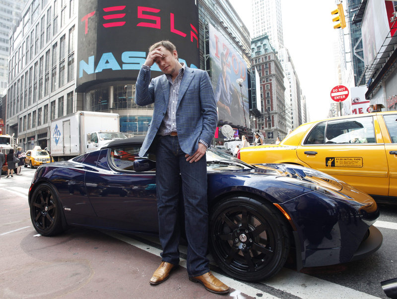 SpaceX owner and Tesla Motors CEO Elon Musk stands near a Tesla car in front of Nasdaq in June 2010. Another Tesla, the high-end, battery-powered Model S, will start being delivered to customers in late June.