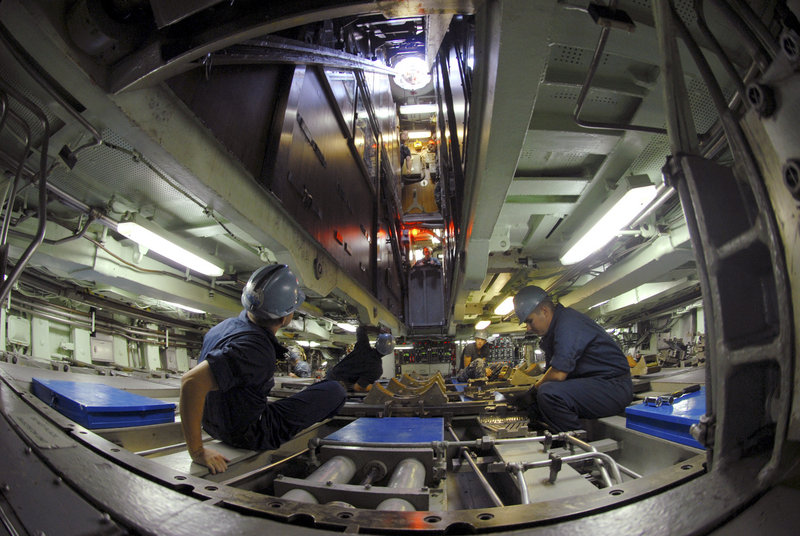 A weapons team prepares to receive a torpedo aboard the USS Albany, a Los Angeles-class attack submarine like the USS Miami that caught fire at the Portsmouth Naval Shipyard. The USS Albany was recently in for maintenance at Newport News Shipbuilding in Virginia.