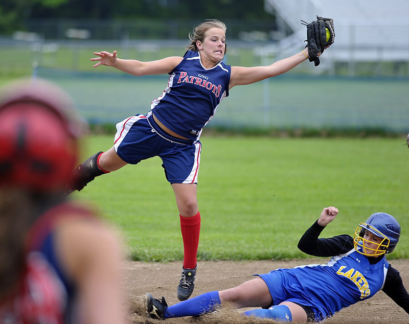 Alexandra Thompson, the third baseman for Gray-New Gloucester, snags the throw as the Lake Region runner reaches safely on a bunt.