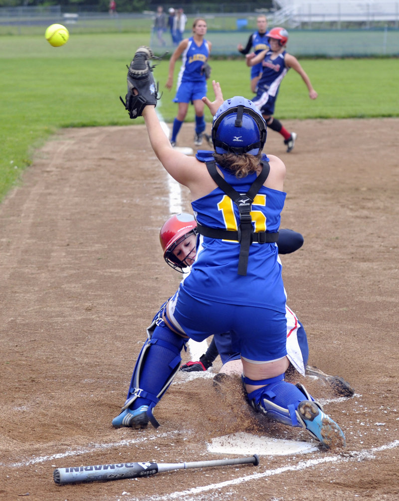 Lake Region catcher Emily Bartlett attempts to reach the ball Friday as Lindsay Nunley of Gray-New Gloucester slides safely home during Gray-New Gloucester’s 6-2 victory in a Western Maine Conference softball game.