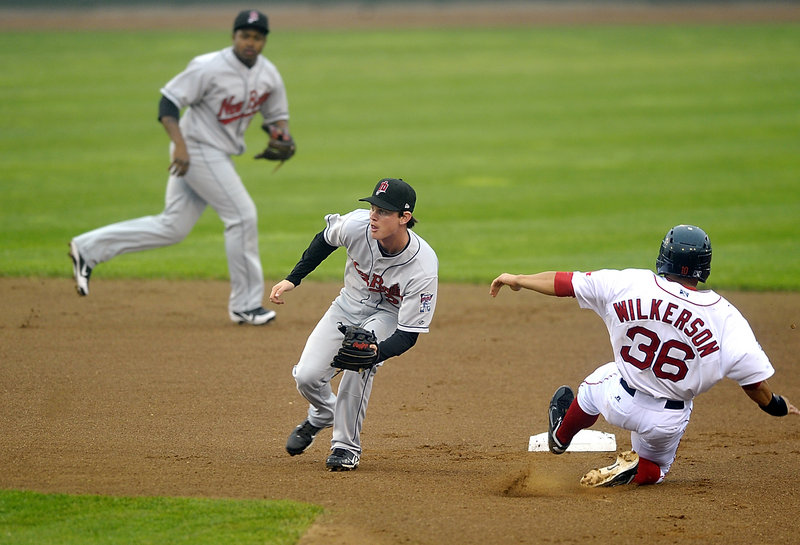 Shannon Wilkerson slides into second base in front of New Britain’s James Beresford following a passed ball. The game was halted after four innings with New Britain leading 1-0 and will restart in the top of the fifth inning at 1 p.m. today at Hadlock Field.