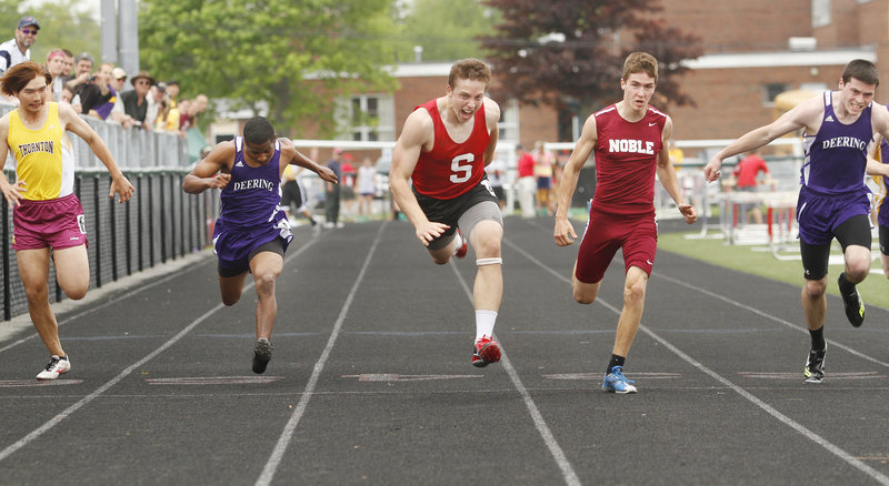 Alex Shain, center, of Sanford pops across the finish line to win the 100 meters in 11.34 seconds, upsetting top-seeded Ethan Beaulier of Noble in the Southern Maine Activities Association outdoor track and field meet Saturday, Shain was the meet’s boys’ MVP.