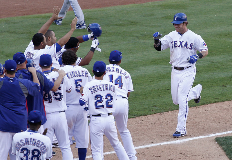 Josh Hamilton approaches home plate after hitting a game-ending home run for the Texas Rangers in an 8-7 win over the Blue Jays on Saturday.