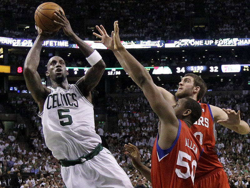 Kevin Garnett of the Boston Celtics shoots over Lavoy Allen, 50, and Spencer Hawes of the Philadelphia 76ers during Boston’s 85-75 victory.