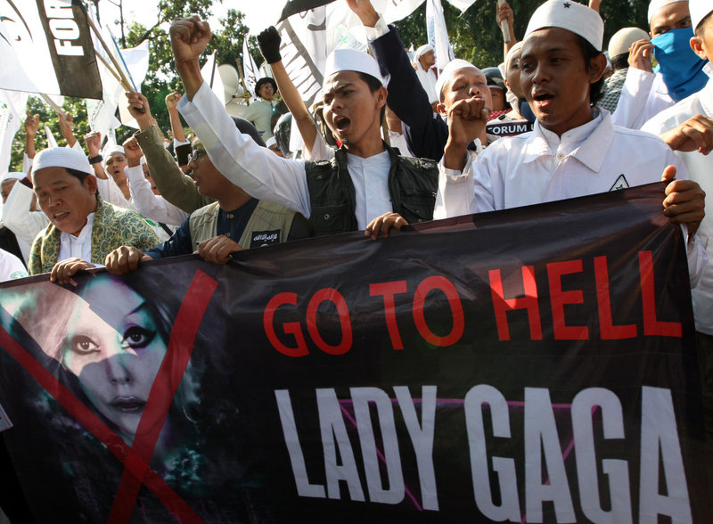 Muslim men shout slogans during a rally against pop singer Lady Gaga’s concert, which had been scheduled for June 3, outside the U.S. Embassy in Jakarta, Indonesia, on Friday. The concert was canceled Sunday.