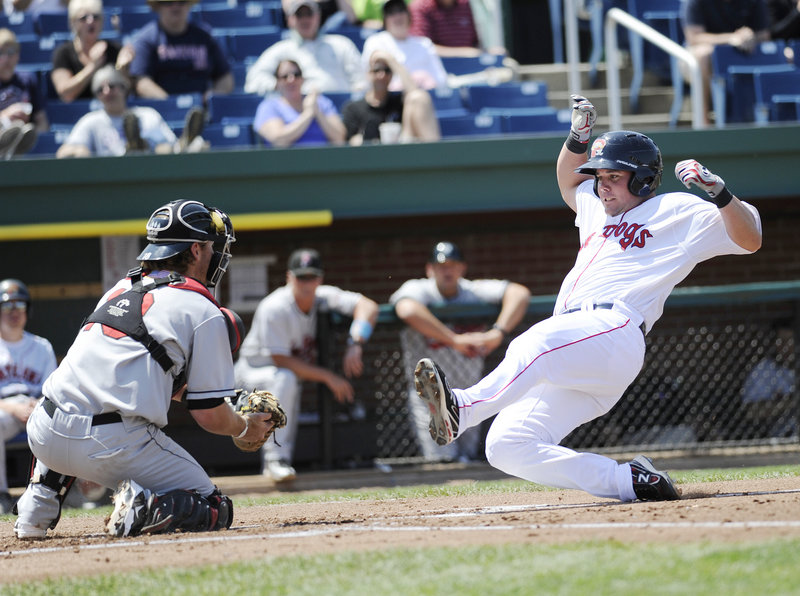 Chris Herrmann of New Britain blocks the plate as Portland’s Juan Carlos Linares attempts to score Sunday. Linares was out on the play, but the Sea Dogs won the game, 8-5.
