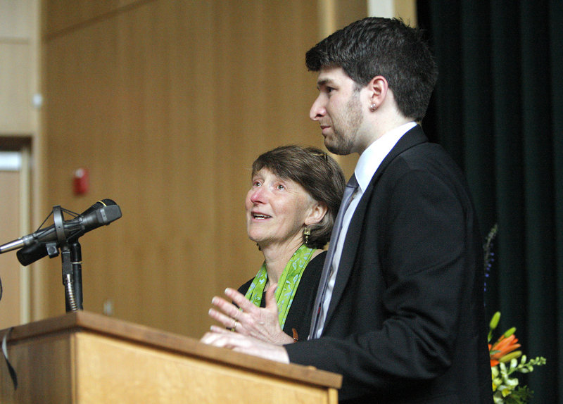 Michael Macklin’s wife, Donna Pendleton, and his son Gabe Faulkner-Macklin thank those who attended a memorial service for Macklin at Waynflete School in Portland on Friday. Franklin Theater, which Macklin helped to build, was overflowing with more than 500 people.
