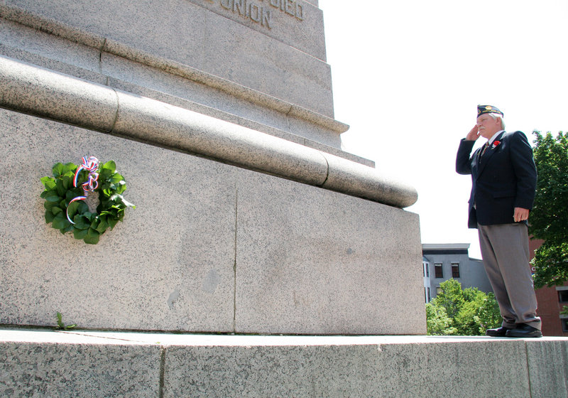 Curtis Ballantine, commander of Portland American Legion Harold T. Andrews Post 17, salutes after laying a wreath at Monument Square during Memorial Day events in Portland. Hundreds of people lined the parade route, and many stayed for the wreath-laying ceremony.
