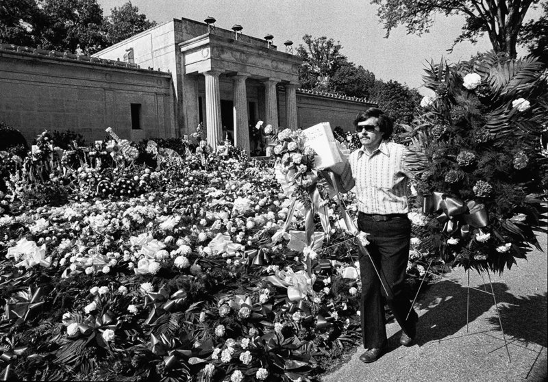 Flowers cover the ground at Elvis Presley’s mausoleum before the singer’s funeral in 1977 in Memphis, Tenn. He was entombed there for two months.