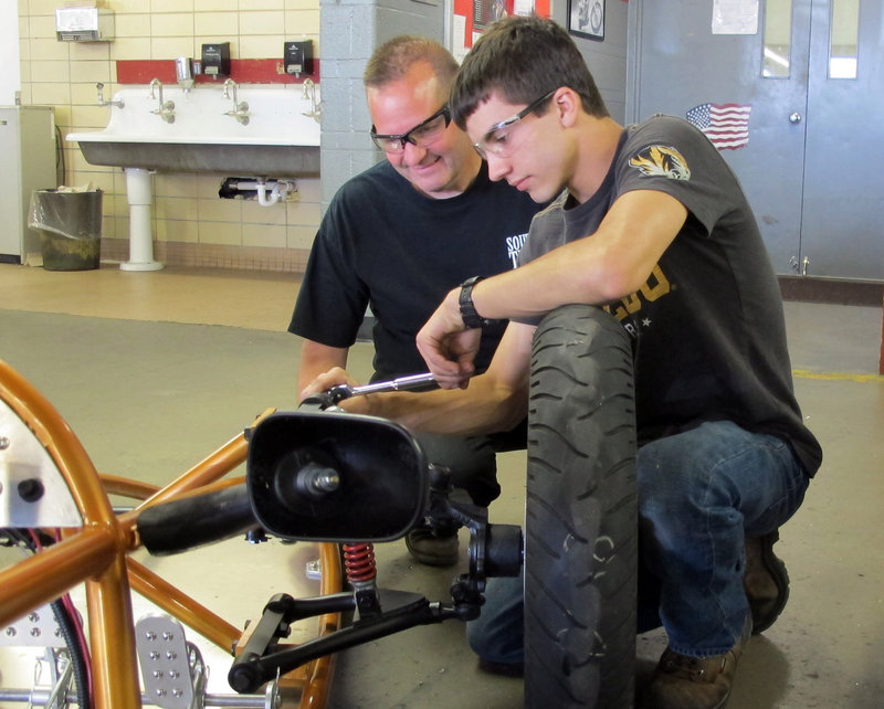 Bob Arcipowski, a precision machining expert, works with student Mike Finklang at South Tech High School in Sunset Hills, Mo., earlier this month.