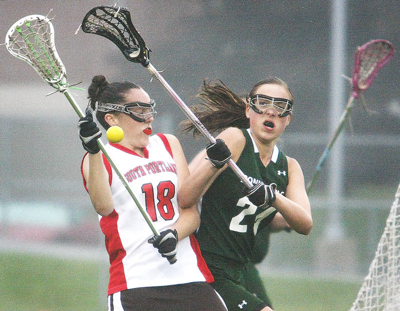Jackie Merrill of South Portland, left, and Shannon Sanborn of Bonny Eagle compete for possession Tuesday during the first half of their schoolgirl lacrosse game. South Portland earned a 10-7 victory at home.