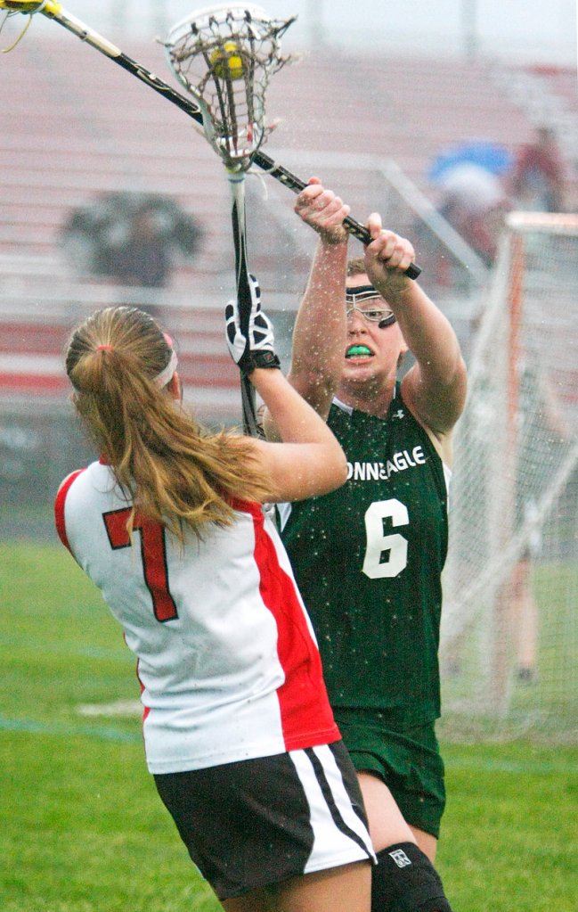 Riley Heroux of Bonny Eagle attempts to block a shot by Lani Edwards of South Portland in the second half.