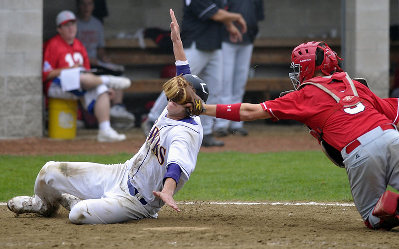 Jack Verrill of Marshwood reaches for the plate as Sanford catcher Ethan Gouin reaches for the tag in the eighth inning Tuesday. Verrill was ruled safe, scoring the run that may give the Hawks the top seed in the Western Class A playoffs with a 3-2 victory.