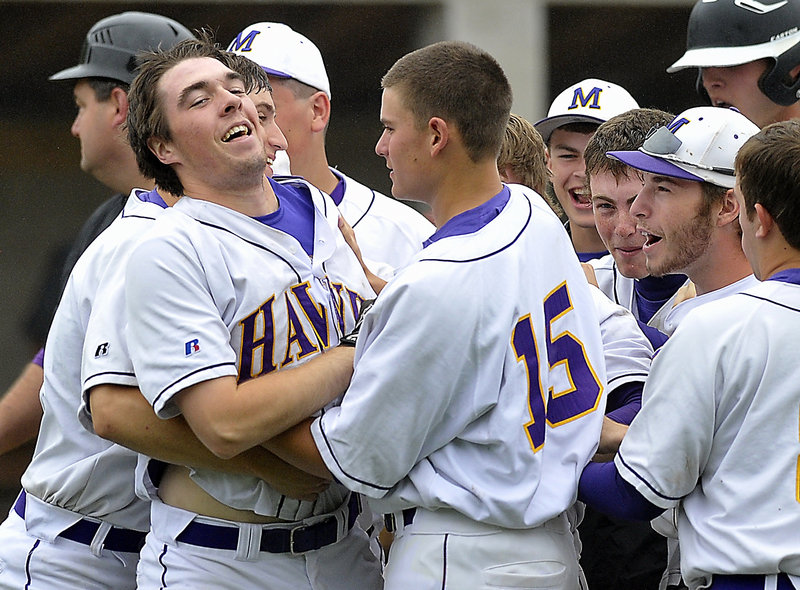 Game over, and Jack Verrill, the winning pitcher who scored on a single by Nick Deveau, celebrates with teammates, including Alex McLean, 15, after the victory at home against Sanford.