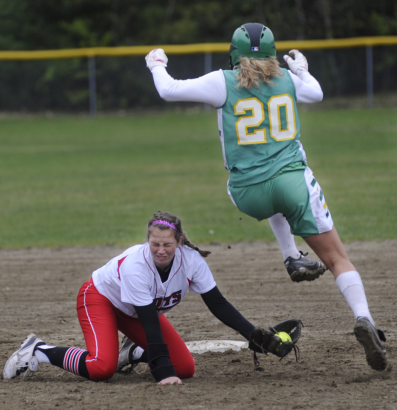 Regan Adams of Massabesic leaps over an attempted tag by South Portland shortstop Danica Gleason to reach second base Wednesday during their Southern Maine Activities Association softball game. South Portland earned a 17-0 victory at home.