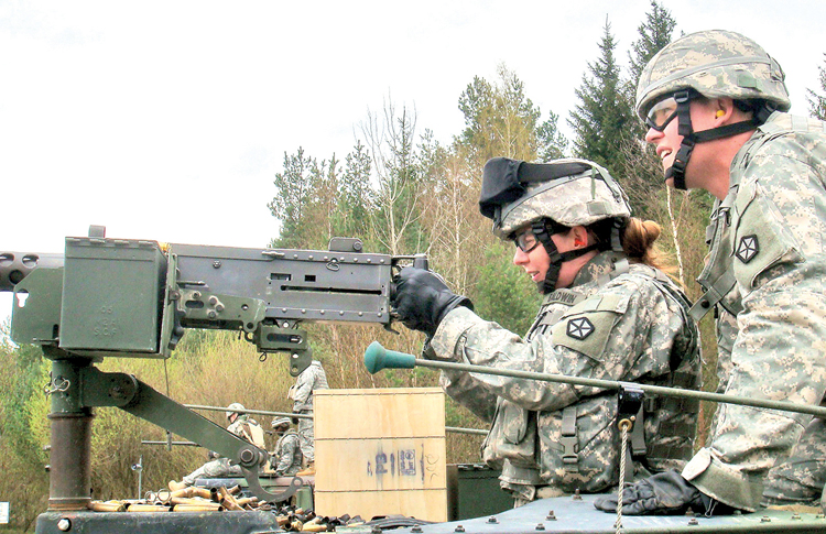 Master Sgt. Renee Baldwin fires a .50-caliber machine gun during training last summer at Joint Multinational Training Command's Grafenwoehr range in Germany. Women will soon be allowed in six additional military occupational specialties normally located within combat units.
