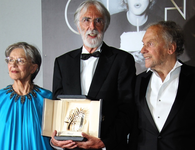 Director Michael Haneke, center, poses Sunday with the Palme d’Or for “Amour,” flanked by actors Emmanuelle Riva and Jean-Louis Trintignant.