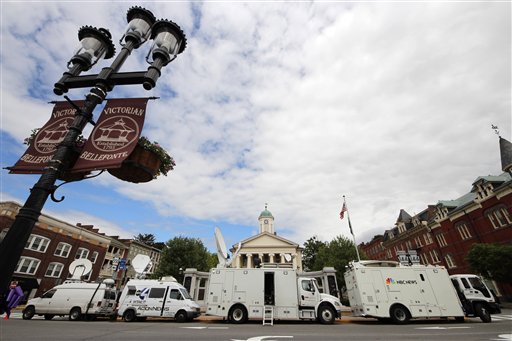 Television satellite trucks set up outside the Centre County Courthouse in Bellefonte, Pa., Monday, June 4, 2012, in preparation for the start of the child sexual abuse trial of former Penn State college football assistant coach Jerry Sandusky, on Tuesday. (AP Photo/Gene J. Puskar)