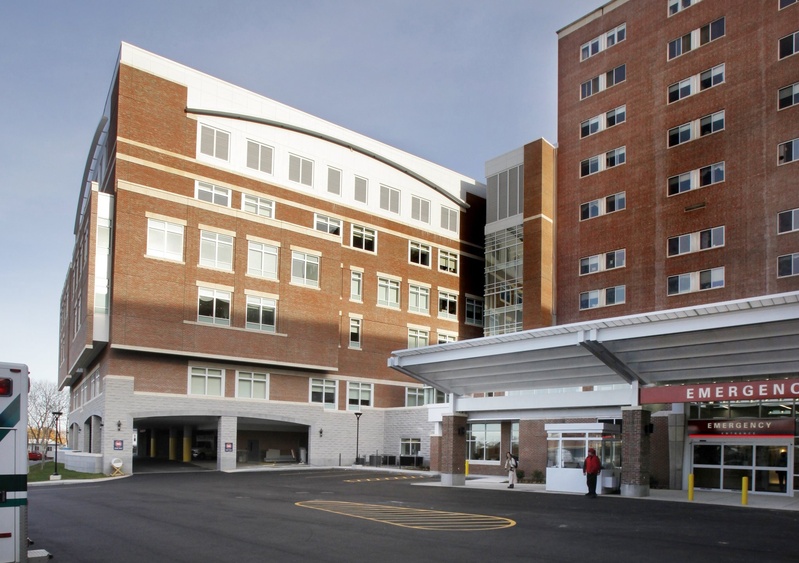 An employee of Maine Medical Center says the hospital treated him unfairly after he raised concerns about a tradition of taking male residents and fellows to a strip club for lap dances during an out-of-state conference.