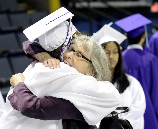 Deering High School faculty member Nancy Murphy embraces graduate Shyneace Lopez prior to the Class of 2012 commencement today at Cumberland County Civic Center.