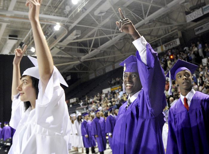 Abdifatah Ali, center, reacts to friends and family during the processional as Deering High School Class of 2012 began commencement exercises at the Cumberland County Civic Center in Portland today.