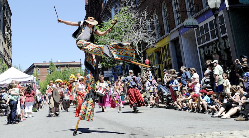 Greg Frangoulis of Shoestring Theater marches down Exchange Street on stilts during the parade that marks the start of the festival.
