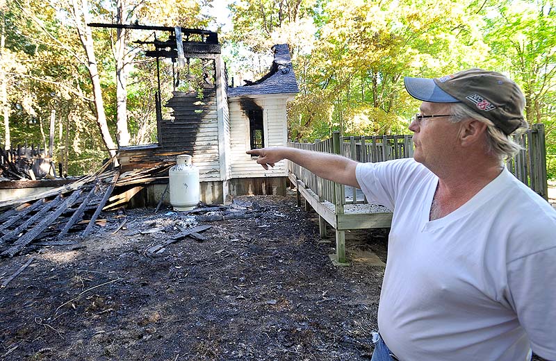 Steve Thibeault, the son of the former pastor, points to damaged remains of the church. Pastor Greg Martin said the building was insured, but that the loss of such a historic building and its memories will be hard to overcome.