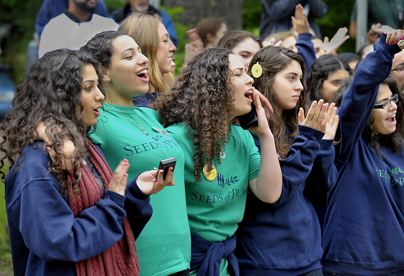 Attendees to the Seeds of Peace camp in Otisfield express joy and excitement during the Opening Ceremonies Wednesday.