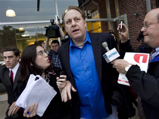 FILE- In this May 21, 2012, file photo, former Boston Red Sox pitcher Curt Schilling, center, is followed by members of the media as he departs the Rhode Island Economic Development Corporation headquarters in Providence, R.I. Schilling has dabbled in politics, World War II history and raised millions for Lou Gehrig's disease, but it's a gamble on his video game company 38 studios that is in danger of failing and possibly leaving Rhode Island taxpayers with the tab on a $75 million loan guarantee that lured the firm from Massachusetts in 2010. (AP Photo/Steven Senne, File)